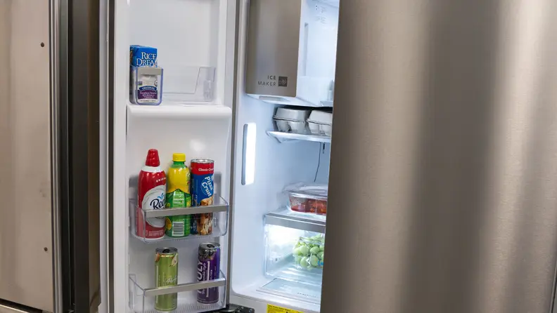 The left top door of a refrigerator stands open