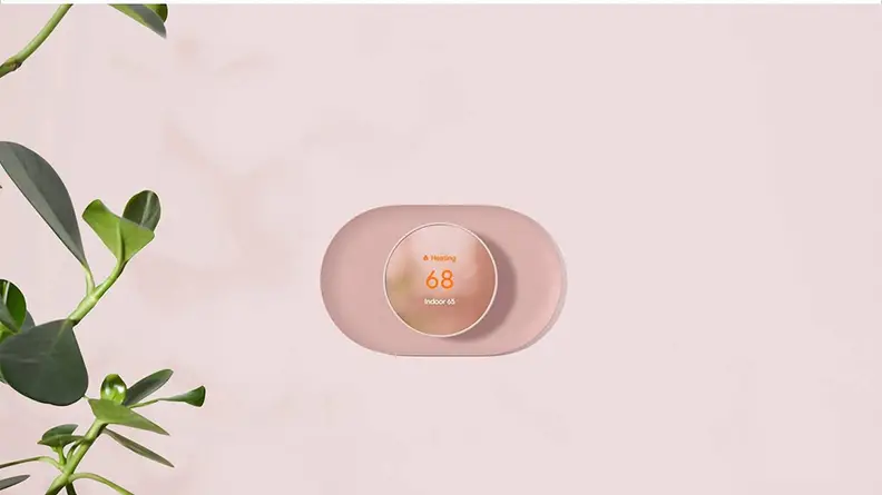 Google Nest Thermostat attached to a wall.