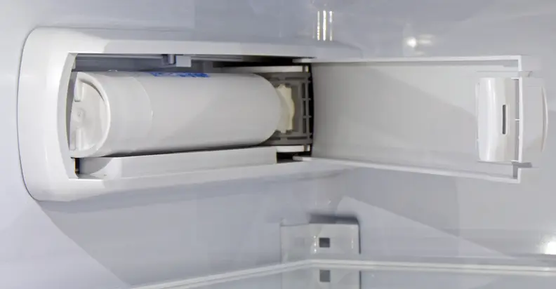 The GE Cafe CFE28TSHSS's water filter is kept out of the way on the upper left wall of the fridge interior.