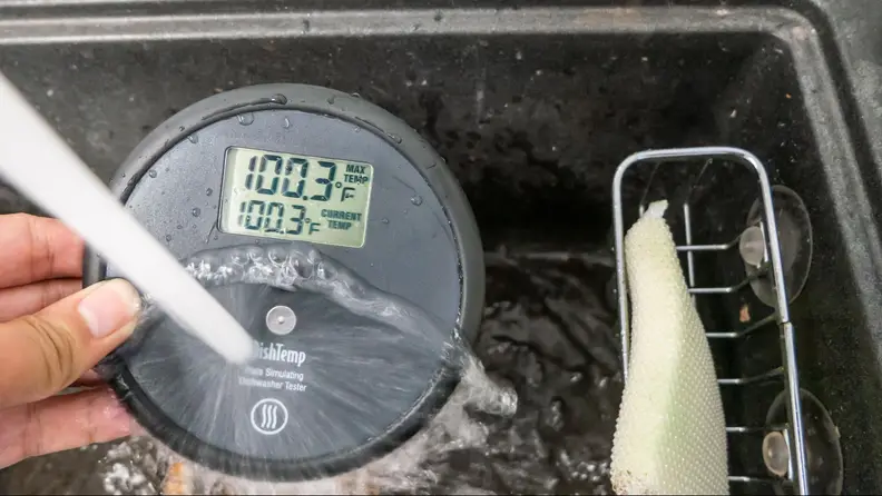A temperature puck measuring the temperature of running water.