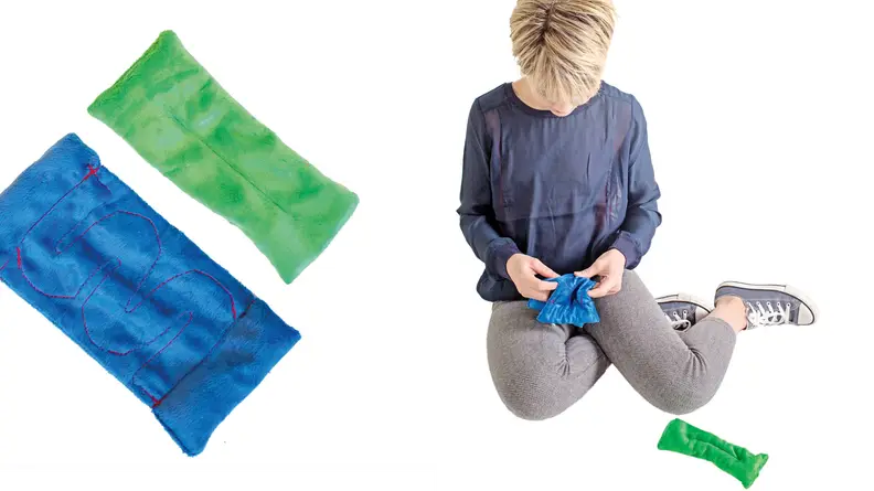 Left: One blue bean bag and one green bean bag; right: A child works a marble through a maze in a bean bag.