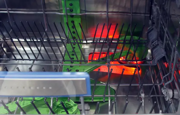 The glowing-red zeolite compartment of the Bosch 800 Series dishwasher.