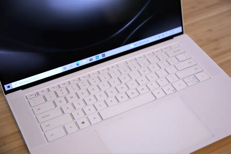 A Dell XPS 15 with OLED display on a desk.