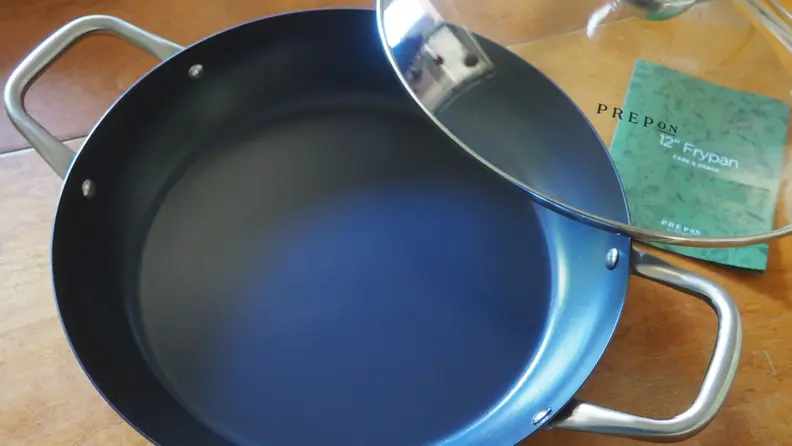 Carbon steel pan with lid on wooden table