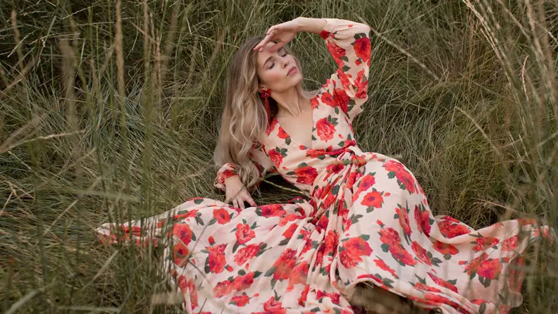woman wearing patterned red dress in field