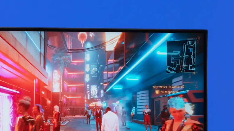 Up close view of the upper right corner of the Gigabyte M27U monitor, with a blue background.
