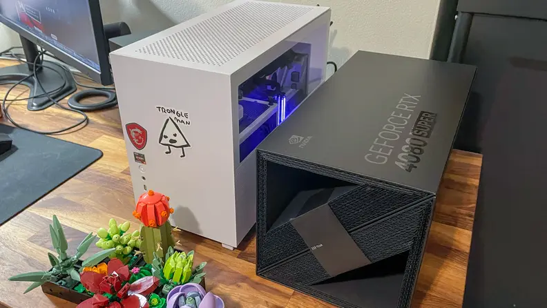 The Nvidia RTX 4080 box next to a white computer case.