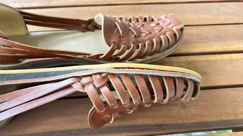 Close-up photograph of a huarache sandal where the sole is separating from the insole.