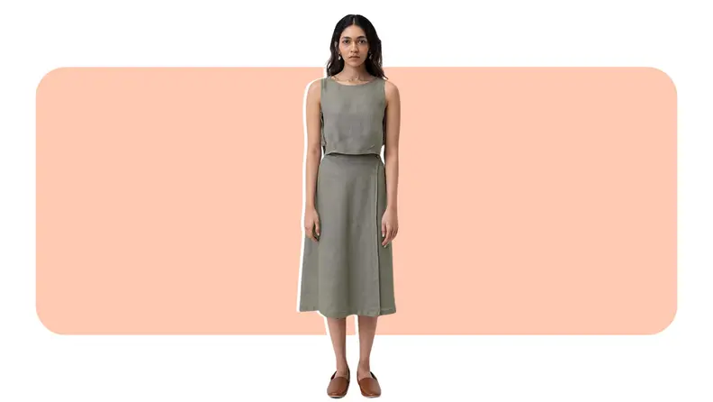 A model wearing a wrap-style midi skirt with a matching crop top.