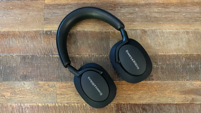 The Bowers & Wilkins Px7 S2 headphones lying flat on a wooden table.