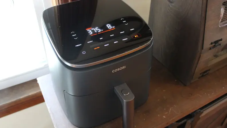 The Cosori TurboBlaze Air Fryer during operation, cooking food at 375 degrees.