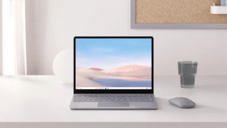 A laptop sits on a minimalistic desk.
