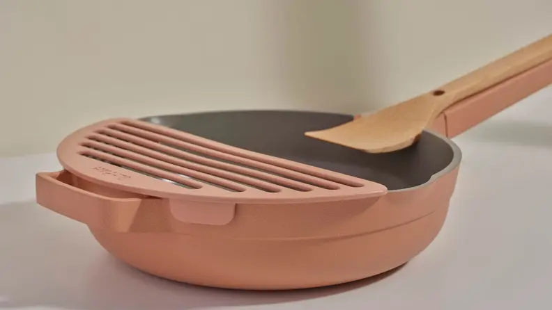 An Always Pan with attached Fry Deck shot from the side, showing where the add-on attaches.