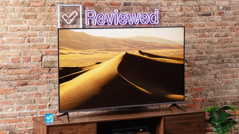 The Roku Plus Series QLED TV with sand dunes onscreen.