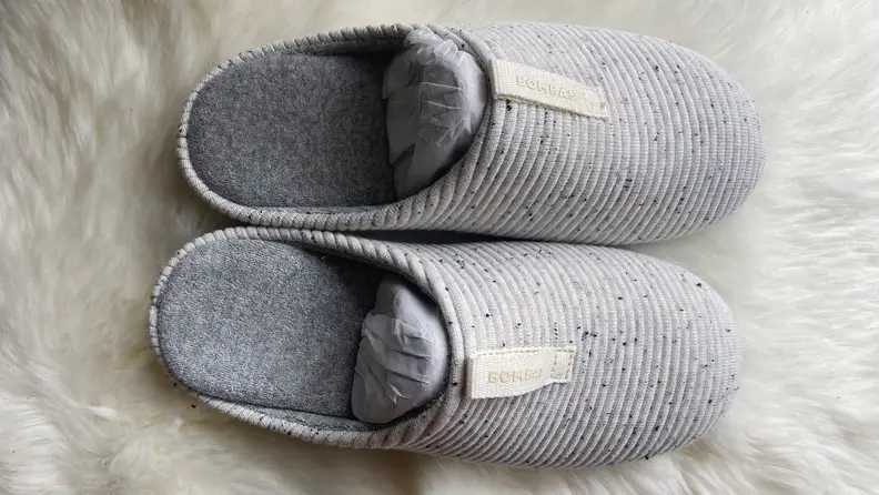 A pair of gray slippers.