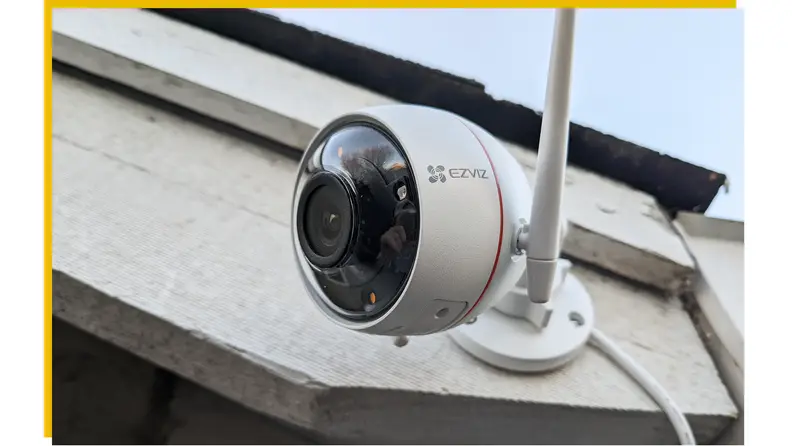 The Ezviz C3W Pro hangs on the side of a house