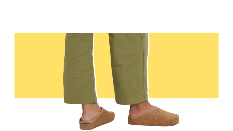 A model wearing corduroy clog-style slippers.