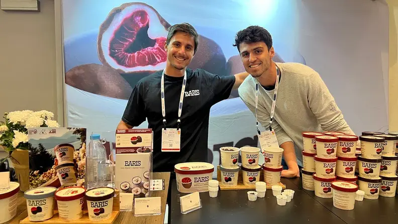 Two people standing in front of Baris Expo West display