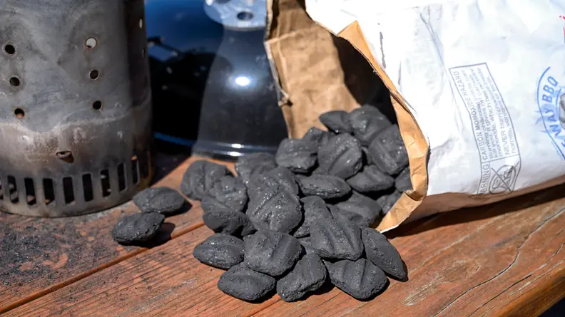 Charcoal pouring out of a bag onto a table
