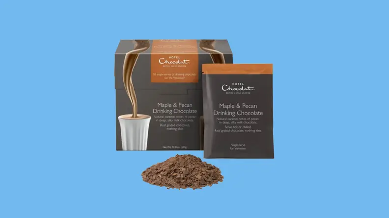 Hot chocolate bag, package and grounds against blue background