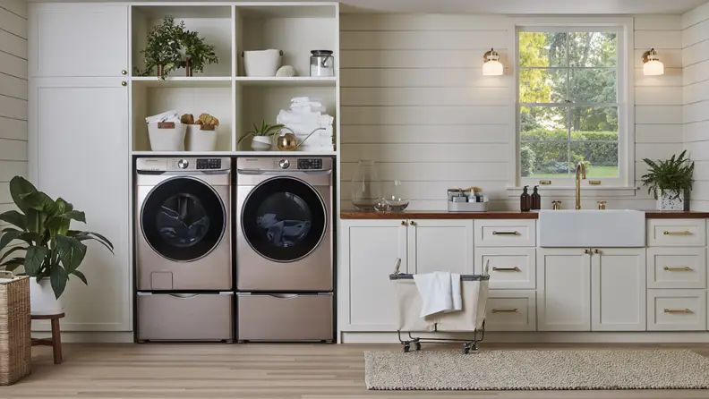 The Samsung WF45R6300AV beside a Samsung washer in a cream laundry room.