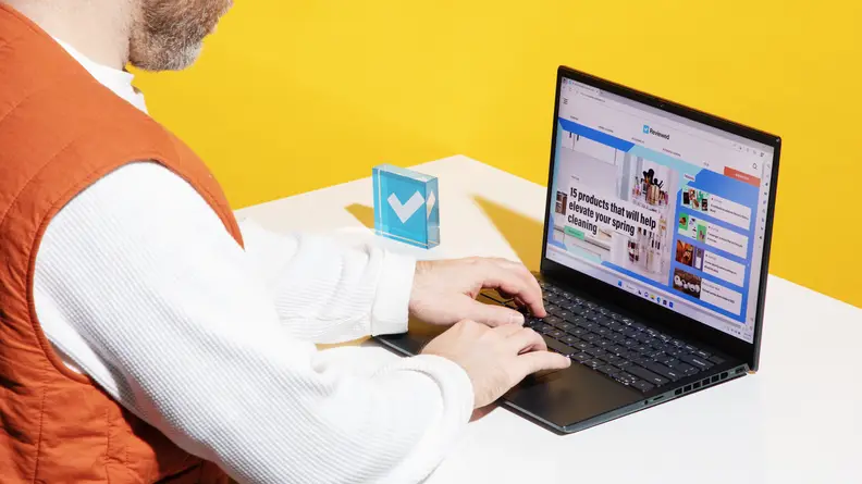 A person typing on the Dell Inspiron 14 Plus keyboard at desk.