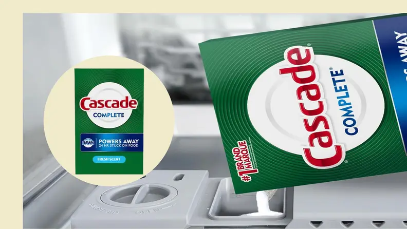 Cascade dishwasher detergent powder poured into the dishwasher.