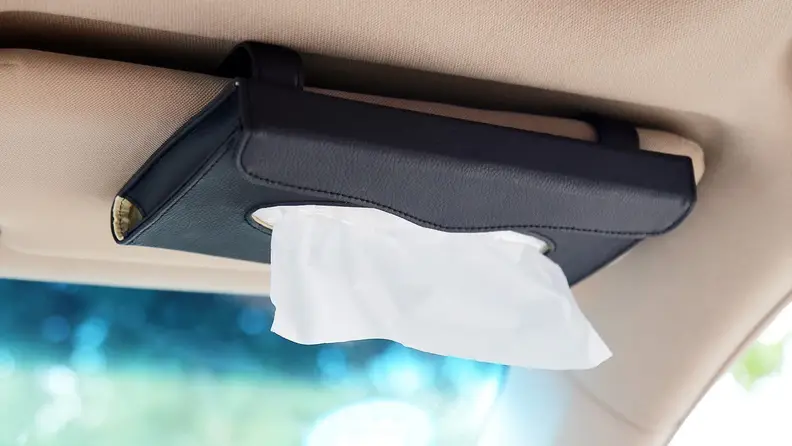 Tissue holder on dashboard in a car.