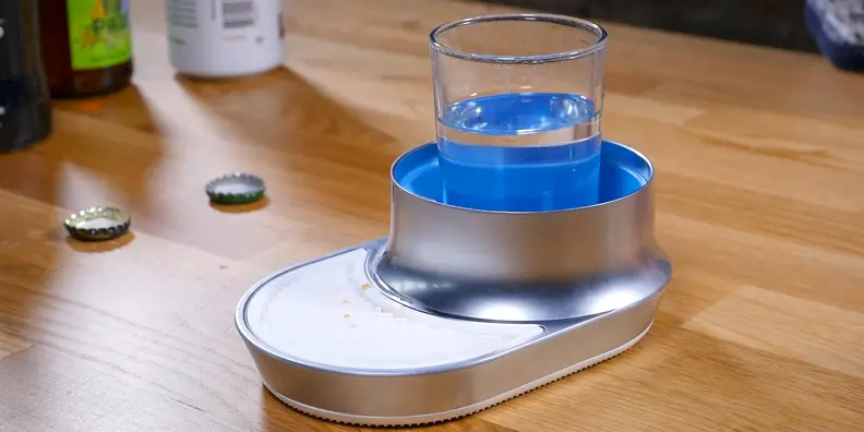 A small glass of warm water in position to clean the Waytap