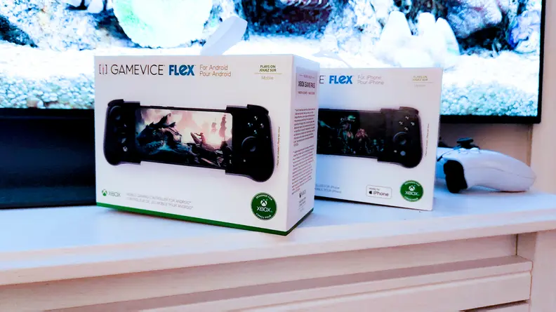 Two boxes for the Gamevice Flex on a TV stand, one for Android and one for iOS.