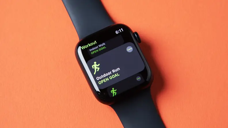 An Apple Watch Series 8 sits against an orange background