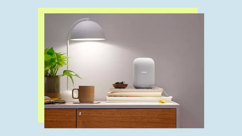 A smart speaker sits on an end table inside a home.
