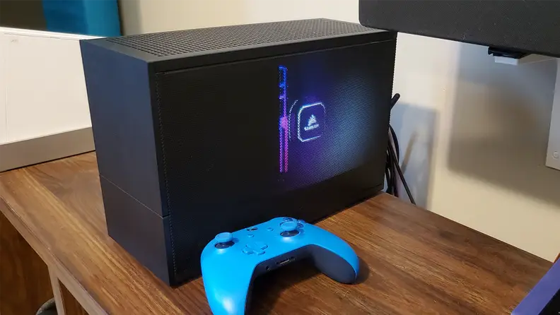 A small computer and an Xbox one controller on a table