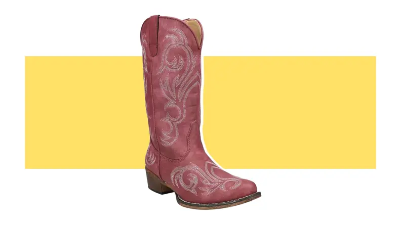 A red suede cowboy boot with white embroidery.