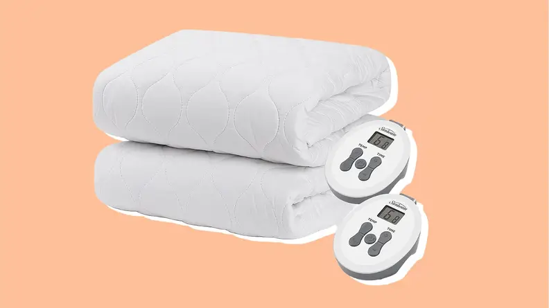 A white mattress pad folded up with controllers next to it.