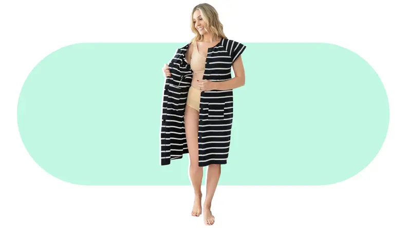 A person modeling an open Gownies Adaptive Hospital Gown.