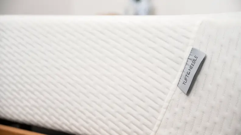 a close up of the tag on the foot of the Tuft & Needle Original mattress