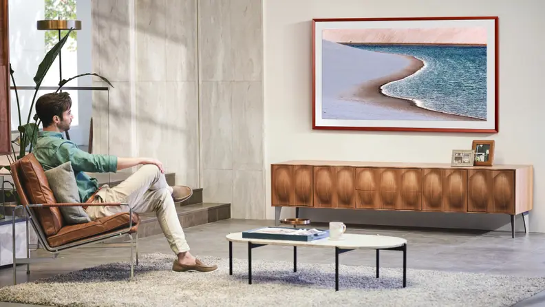 Samsung's The Frame lifestyle TV hanging on the wall in a living room setting