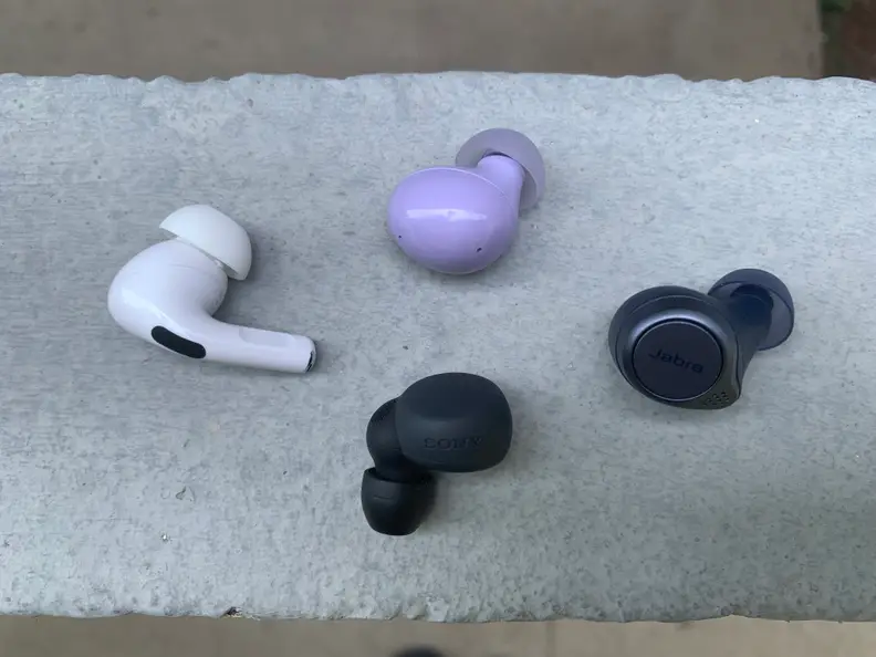 The black Sony LinkBuds S lie next to the Jabra Elite Active 75t, Apple Airpods Pro, and Samsung Galaxy Buds2.
