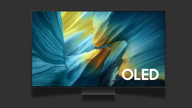 A TV with a colorful screen sits on a black background