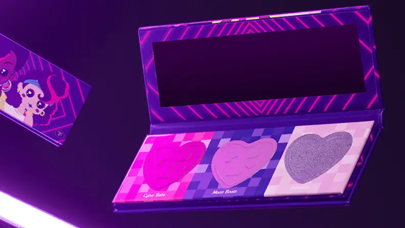 A Trixie Mattel Cosmetics makeup palette with shades of purple, pink, and fuschia.
