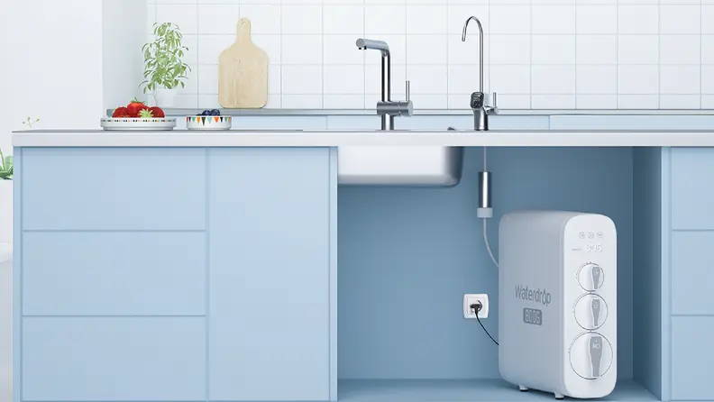 White, rectangular water filter under a sink on a pale blue countertop