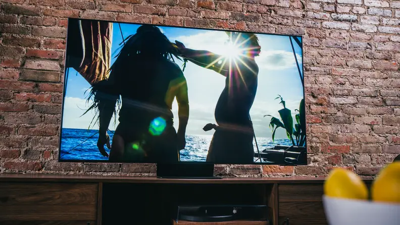 Samsung QN90A TV showing two shadowy figures in front of a brilliant sunburst