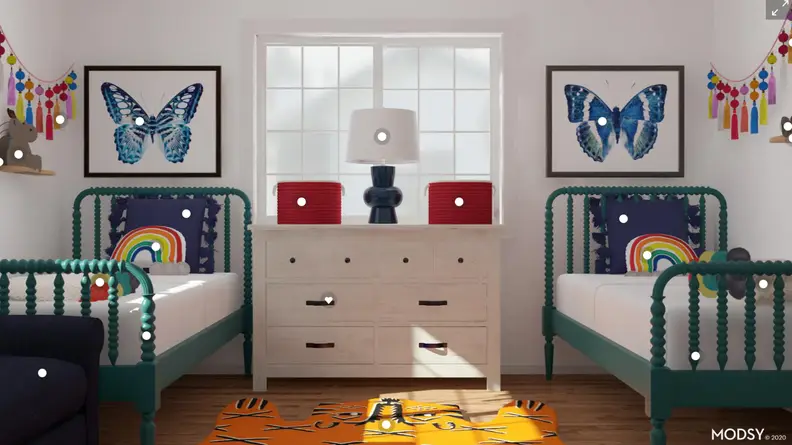 Twin beds in a bedroom with butterfly pictures