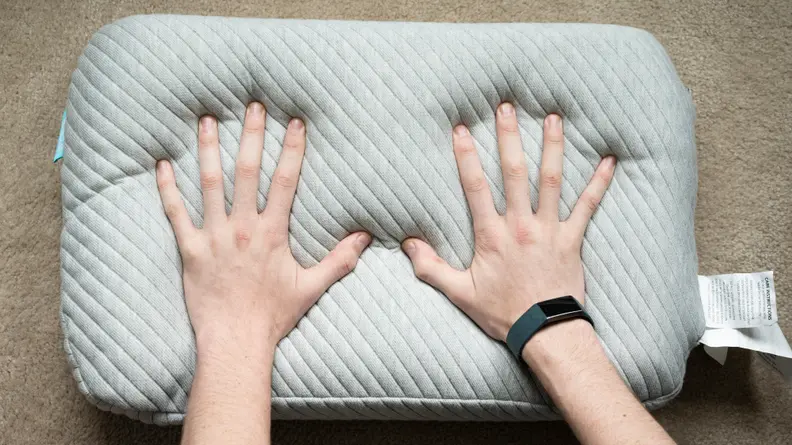 hands push into the Leesa pillow foam