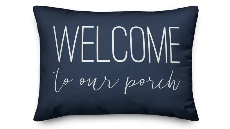 Blue pillow that says Welcome to our porch