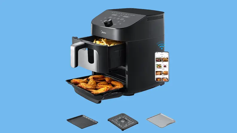 Product shot of the Midea 10-in-1 11-quart Two-zone Air Fryer with both drawers pulled out to reveal cooked chicken wings and french fries.
