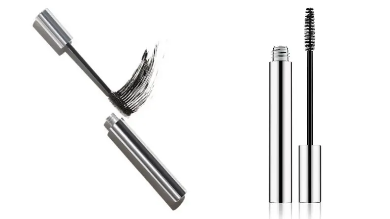 On the left: The silver tube of the Clinique Naturally Glossy Mascara lays on a white background with the wand outside of the cylindrical tube swatching the mascara. On the right: The same tube of mascara stands up with the wand standing next to the tube.