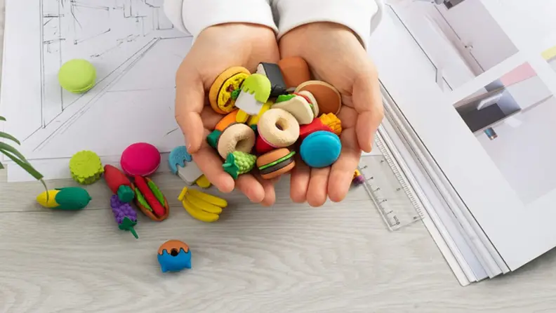 A handful of mini erasers in the shape of all sorts of tiny foods