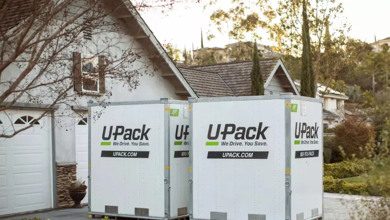 Two portable storage cubes in front of a driveway